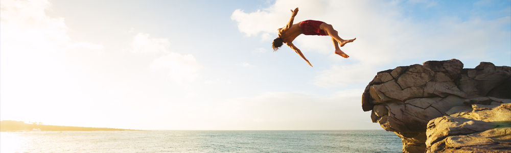 Man jumping off a cliff